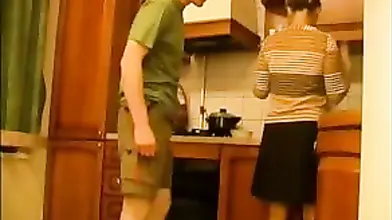 Good looking milf gets seduced and fucked in the kitchen