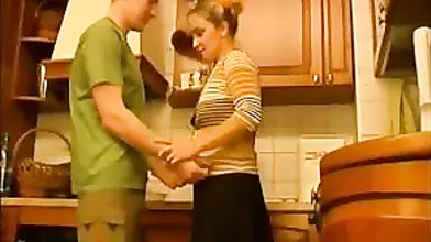 Good looking milf gets seduced and fucked in the kitchen