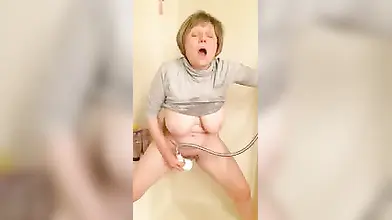 Short-haired mature with big tits loves some hot shower action