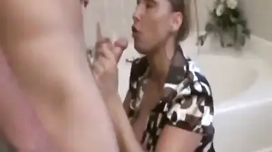 Attractive milf Stacie Starr blows young ramrod in the bathroom