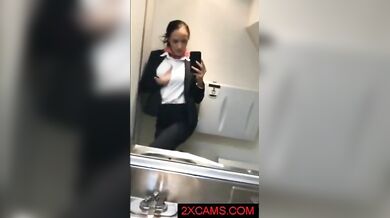 Kinky mature stewardess in stockings masturbates in the airplane toilet