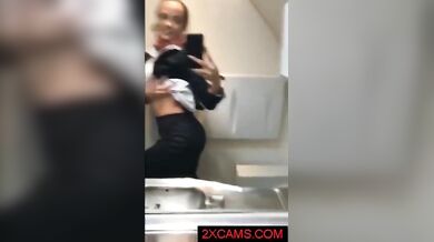 Kinky mature stewardess in stockings masturbates in the airplane toilet