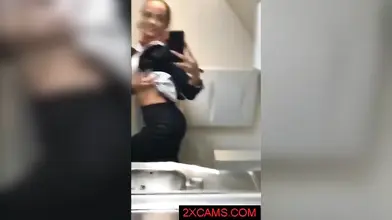 Kinky mature stewardess in stockings masturbates in the airplane toilet