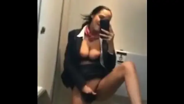 Kinky mature stewardess in stockings masturbates in the airplane toilet