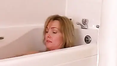 Mature slut spreads her hairy cunt wide in the bathtub