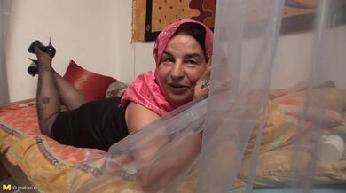 Naughty mature granny with big jugs plays with a dildo