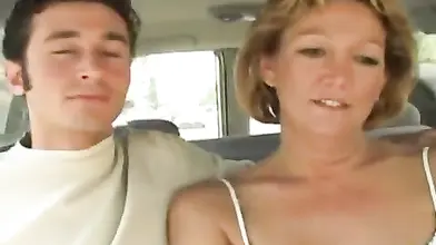 Hot cougar MILF bangs with a young guy in car