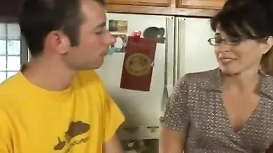 Lusty MILF eats a hard young cock in the kitchen