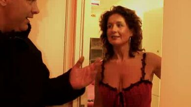 Trashy mature prostitute in fishnet stockings offers her sexual services