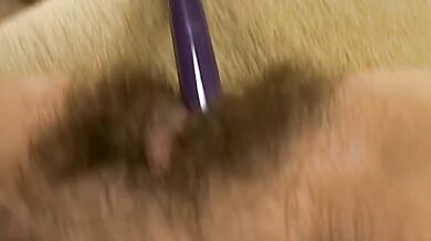 Hairy mature bitch plays with her favorite dildo on sofa