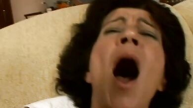 Hairy mature bitch plays with her favorite dildo on sofa