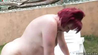 Mature Redhead Rides in Backyard